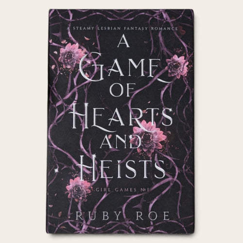 The book cover of 'A Game of Hearts and Heists' by Ruby Roe, featuring a dark background with purple vine patterns and pink flowers, displayed on a light beige background.