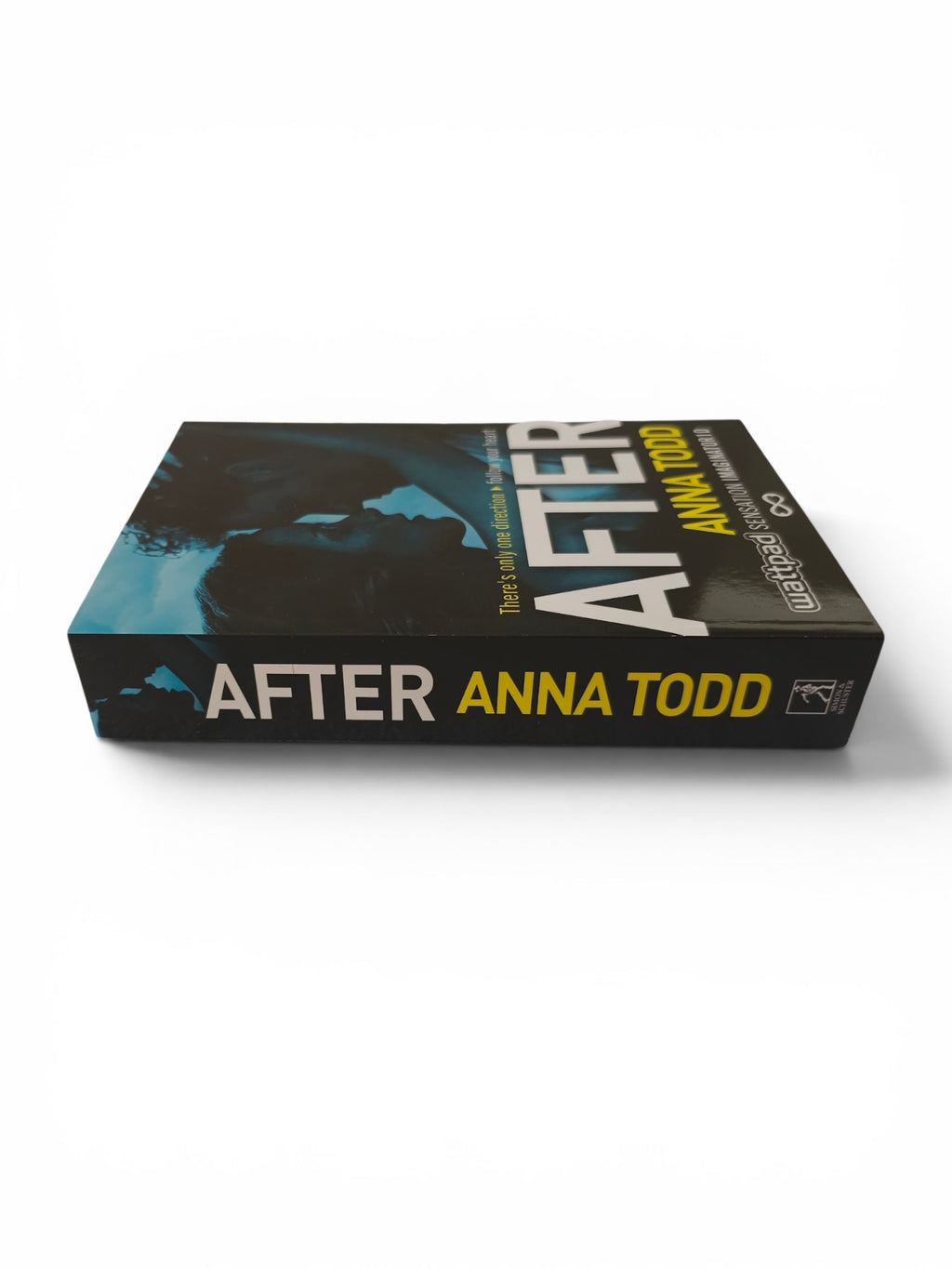 A book titled 'After' by Anna Todd, shown at an angle on a clean white background. The cover is predominantly black with a blue-toned graphic design and features the title in large white and yellow text.