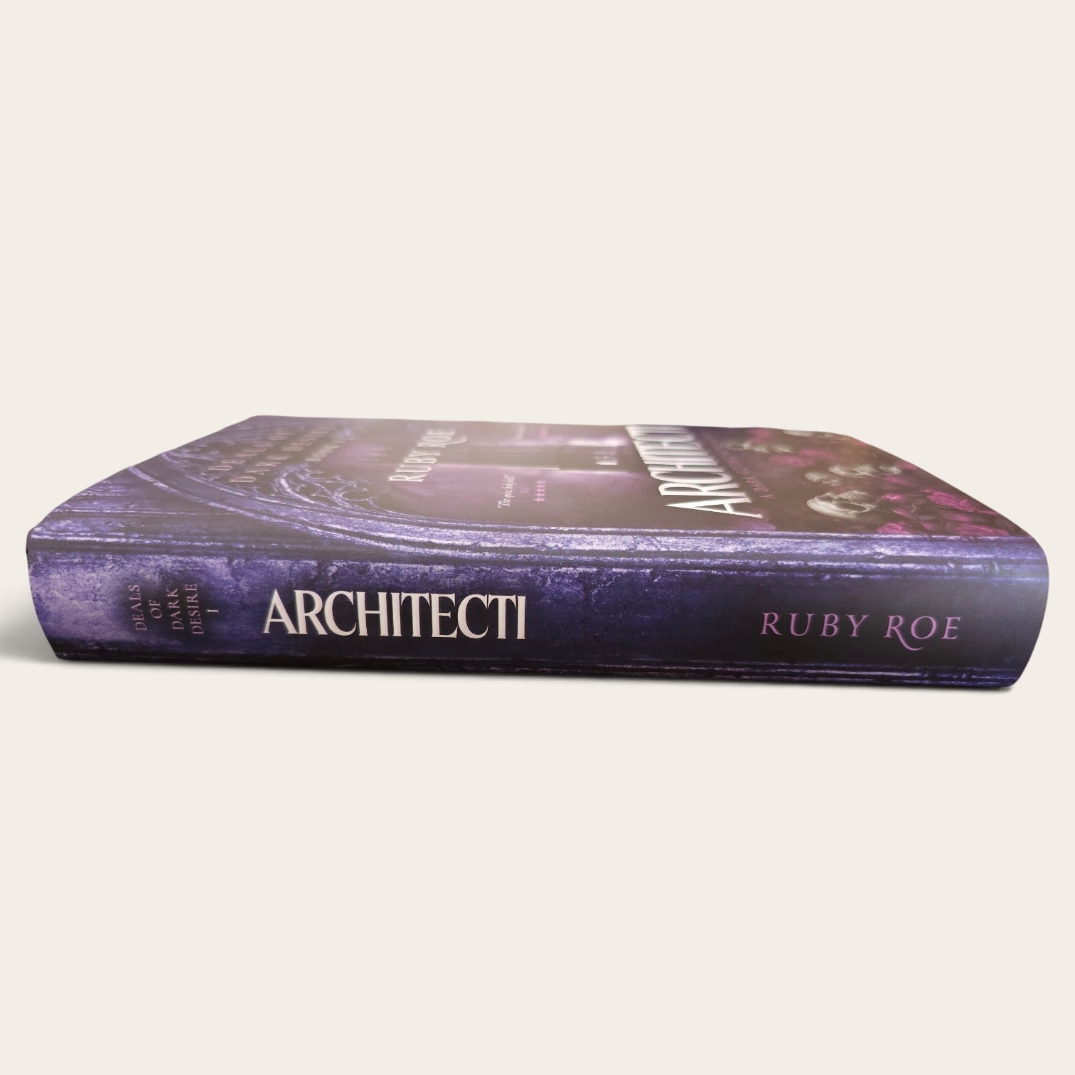 The book 'Architecti' by Ruby Roe, featuring a dark purple and black cover with white title text, shown on a light beige background.