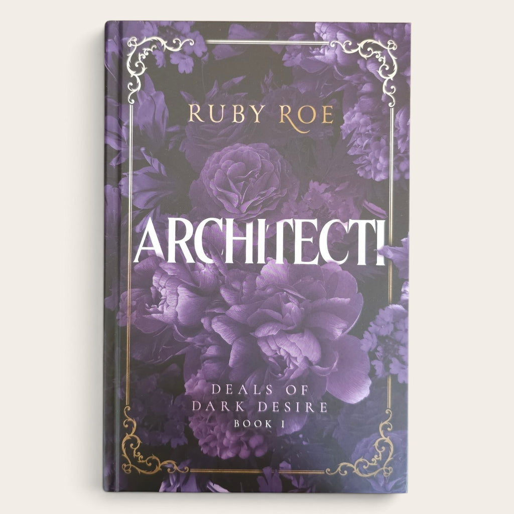 A hardcover book titled 'ARCHITECTI' by Ruby Roe, featuring a dark purple floral cover with gold ornate corner details and white title lettering, shown against a light beige background.