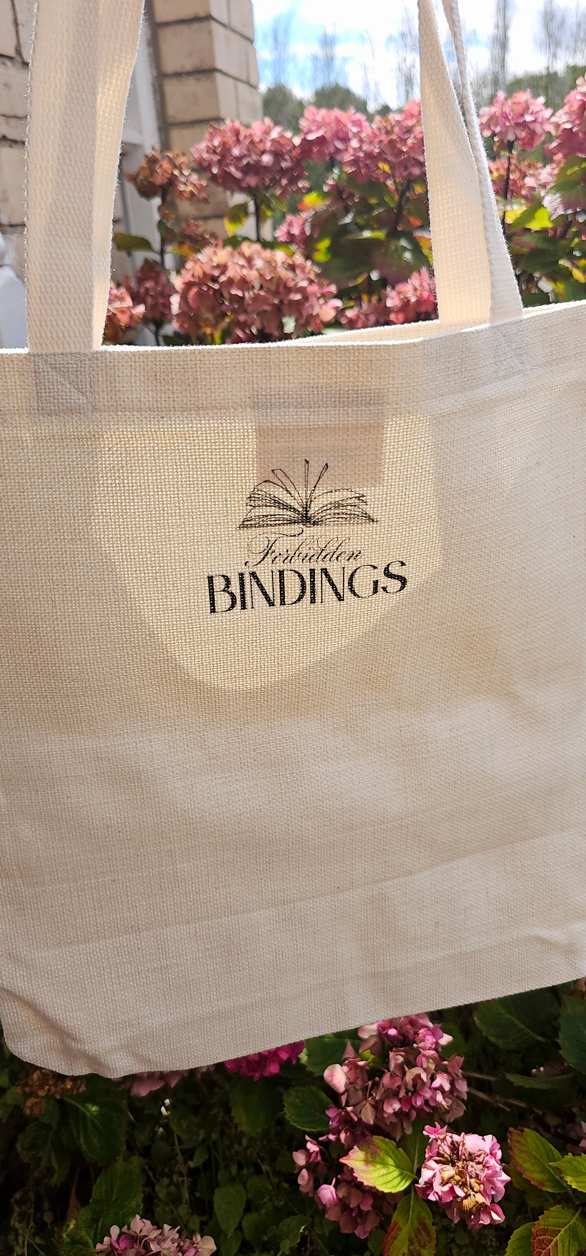 The back of the tote bags with the 'Forbidden Bindings' branding on