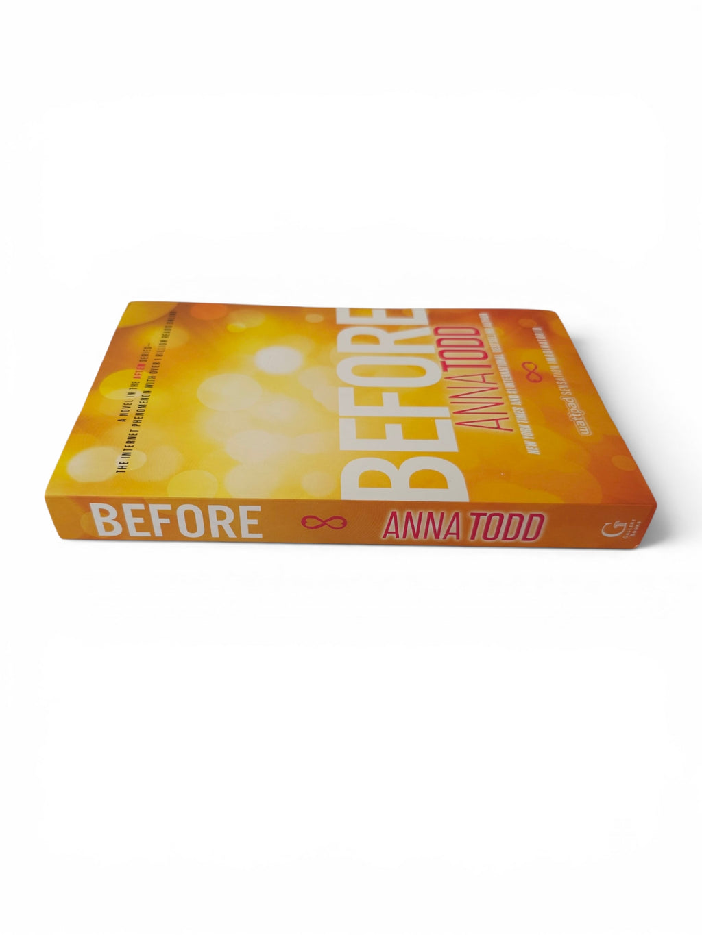 The book cover of 'Before' by Anna Todd, featuring a vibrant orange and yellow bokeh background with bold white and pink lettering, shown on a clean white background.