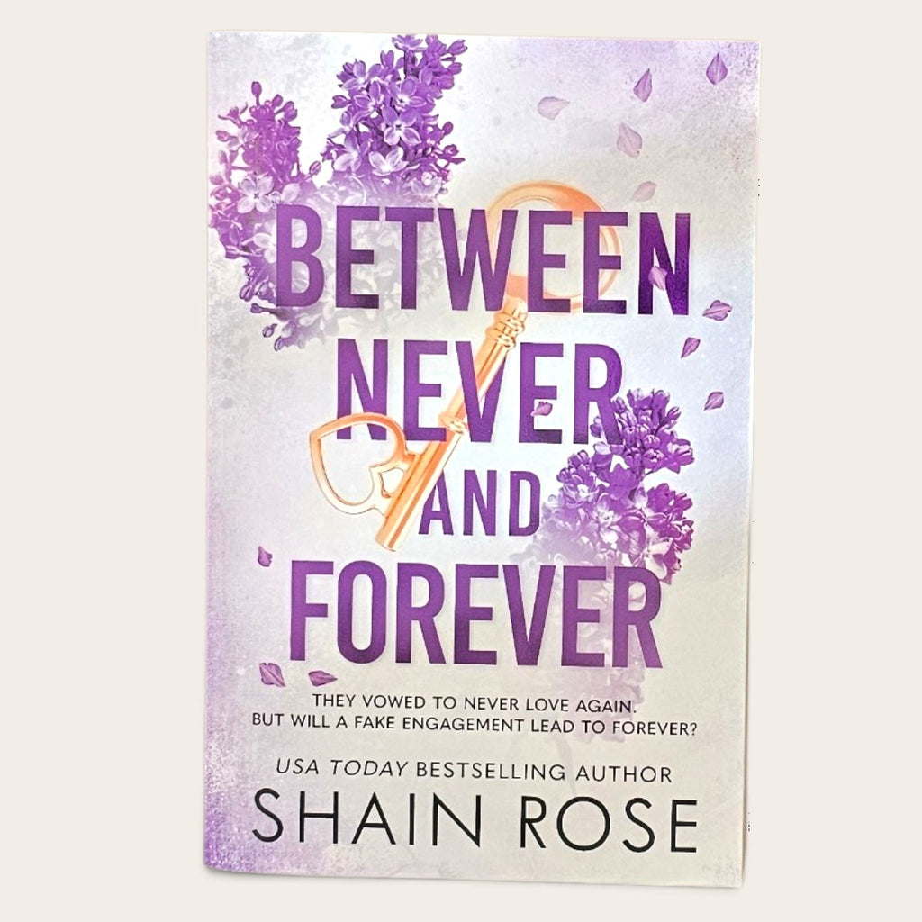 Book cover for 'Between Never and Forever' by Shain Rose, featuring purple lavender flowers, a gold ring, and a white background with a soft purple gradient.