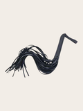 Black flogger on a beige background