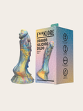 A 7.1-inch dragon dildo by F**KLORE shown next to its retail packaging box. The product features an iridescent, multicolored finish with shifting hues of blue, yellow, and purple, while the box displays a matching graphic illustration.