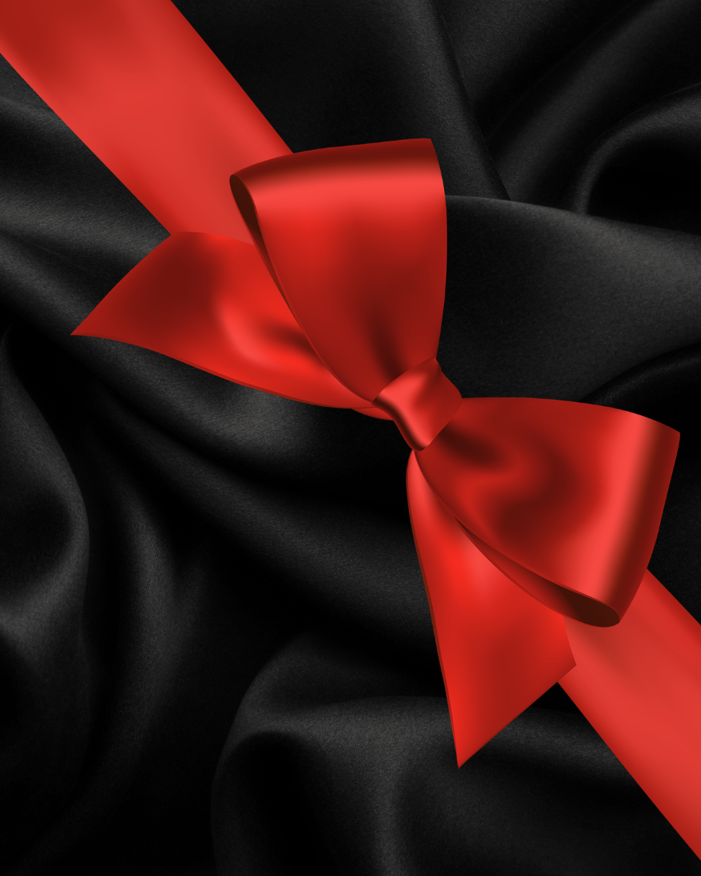 A close-up of draped black satin fabric with a bright red ribbon tied into a bow and running diagonally across the frame.