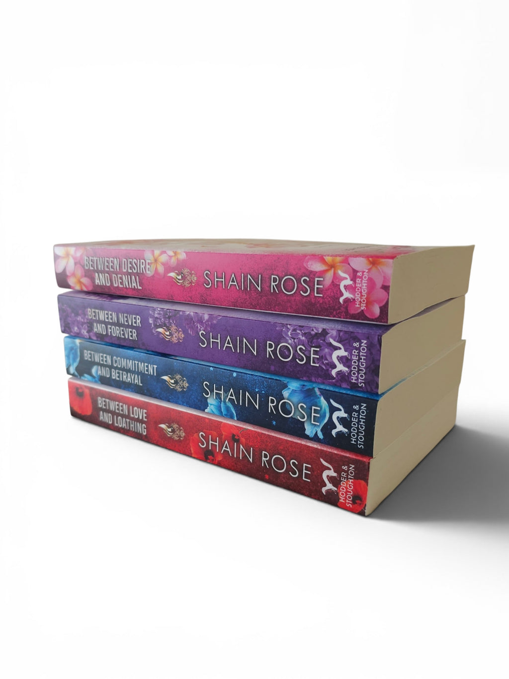 A stack of four romance novels by Shain Rose, showing the colorful spines of the book series Hardy Billionaire Brothers against a plain white background.