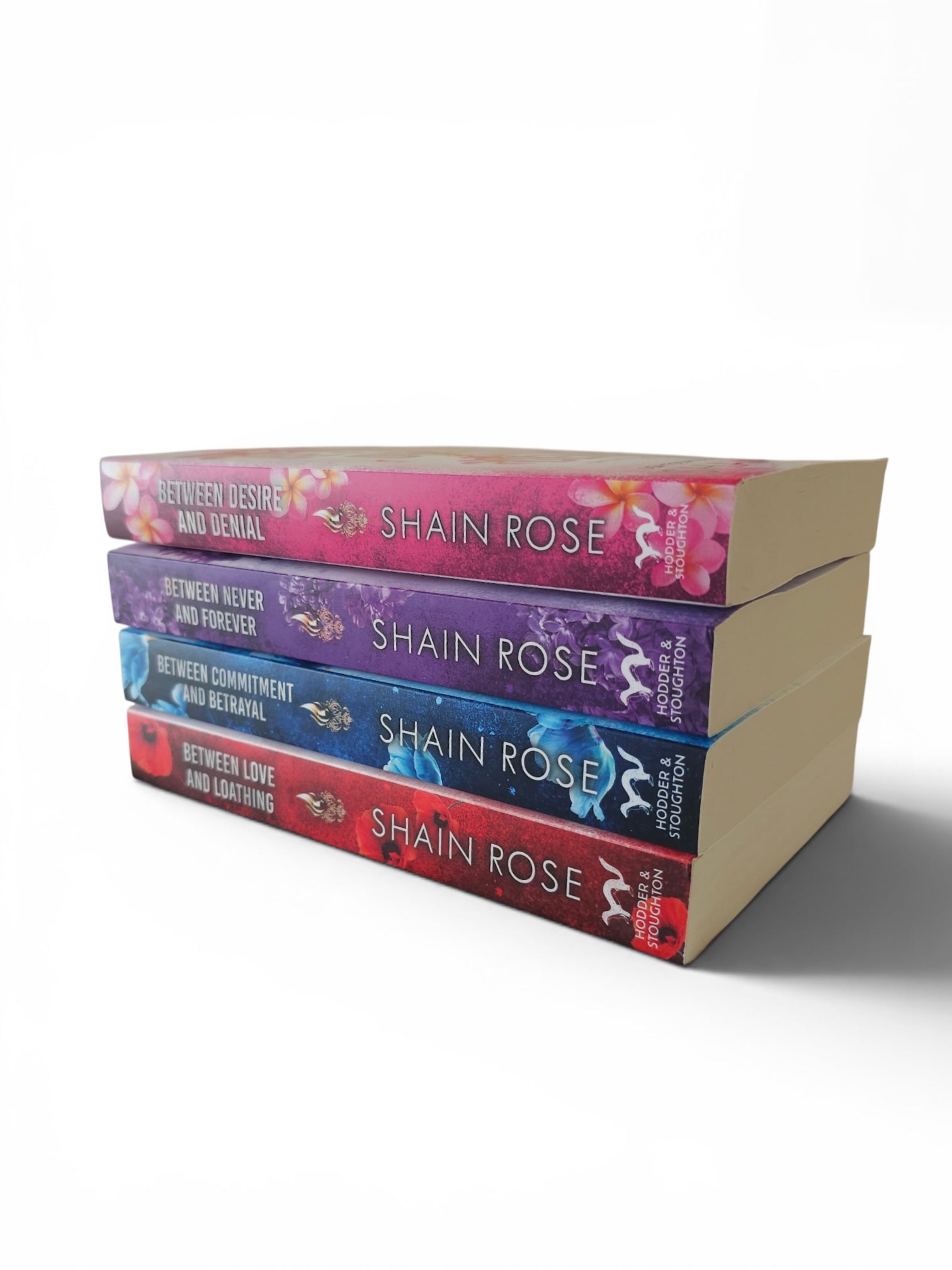 A stack of four romance novels by Shain Rose, showing the colorful spines of the book series Hardy Billionaire Brothers against a plain white background.