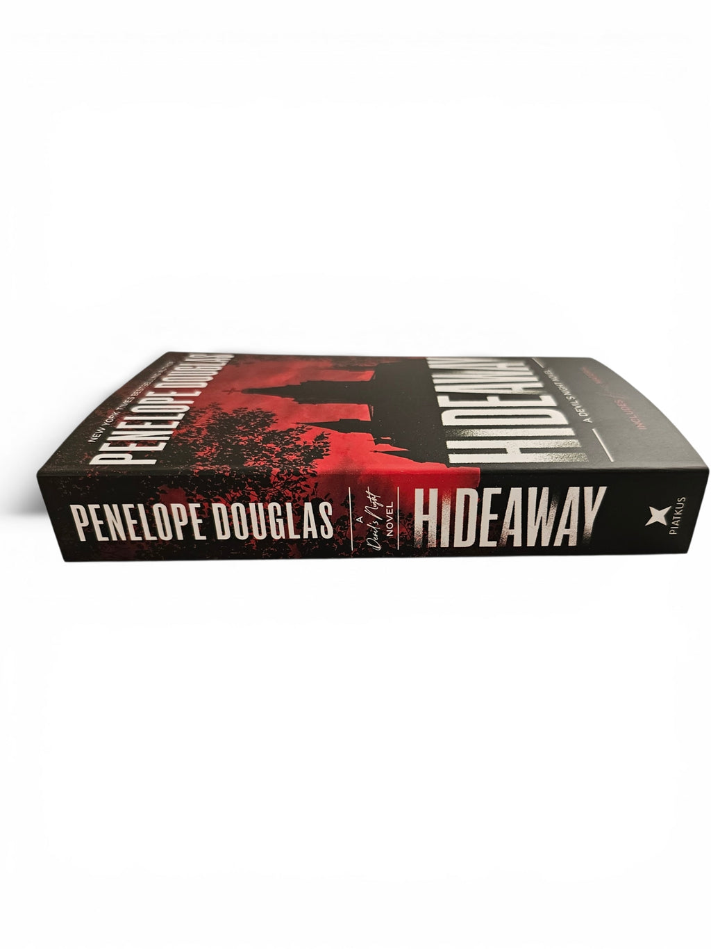 A hardcover book titled 'Hideaway' by Penelope Douglas, featuring a black and red cover design with bold white typography, photographed on a clean white background.