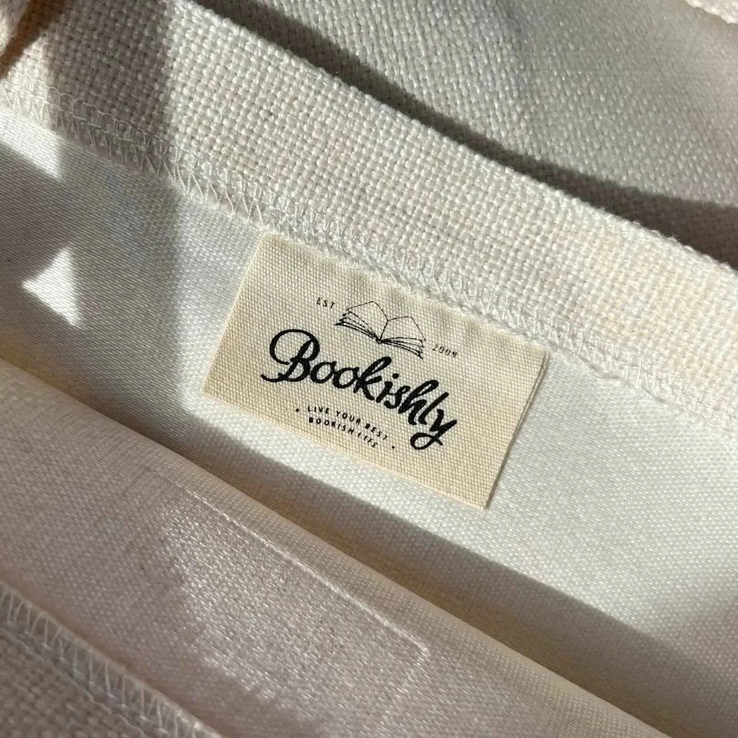 Inner tag of tote bag showing a "bookishly" logo