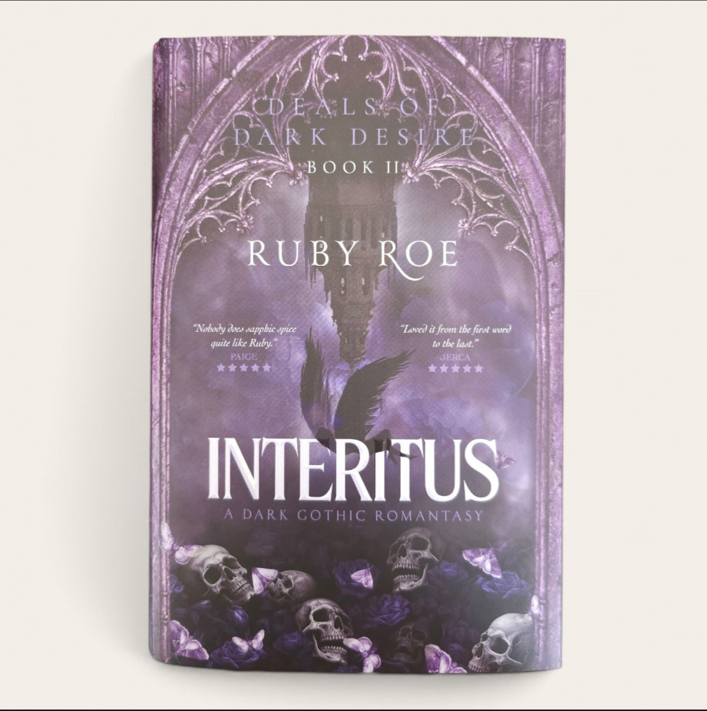Book cover of 'Interitus' by Ruby Roe, featuring a dark gothic design with purple and black tones, skulls, butterflies, and a central bird silhouette under an ornate archway.
