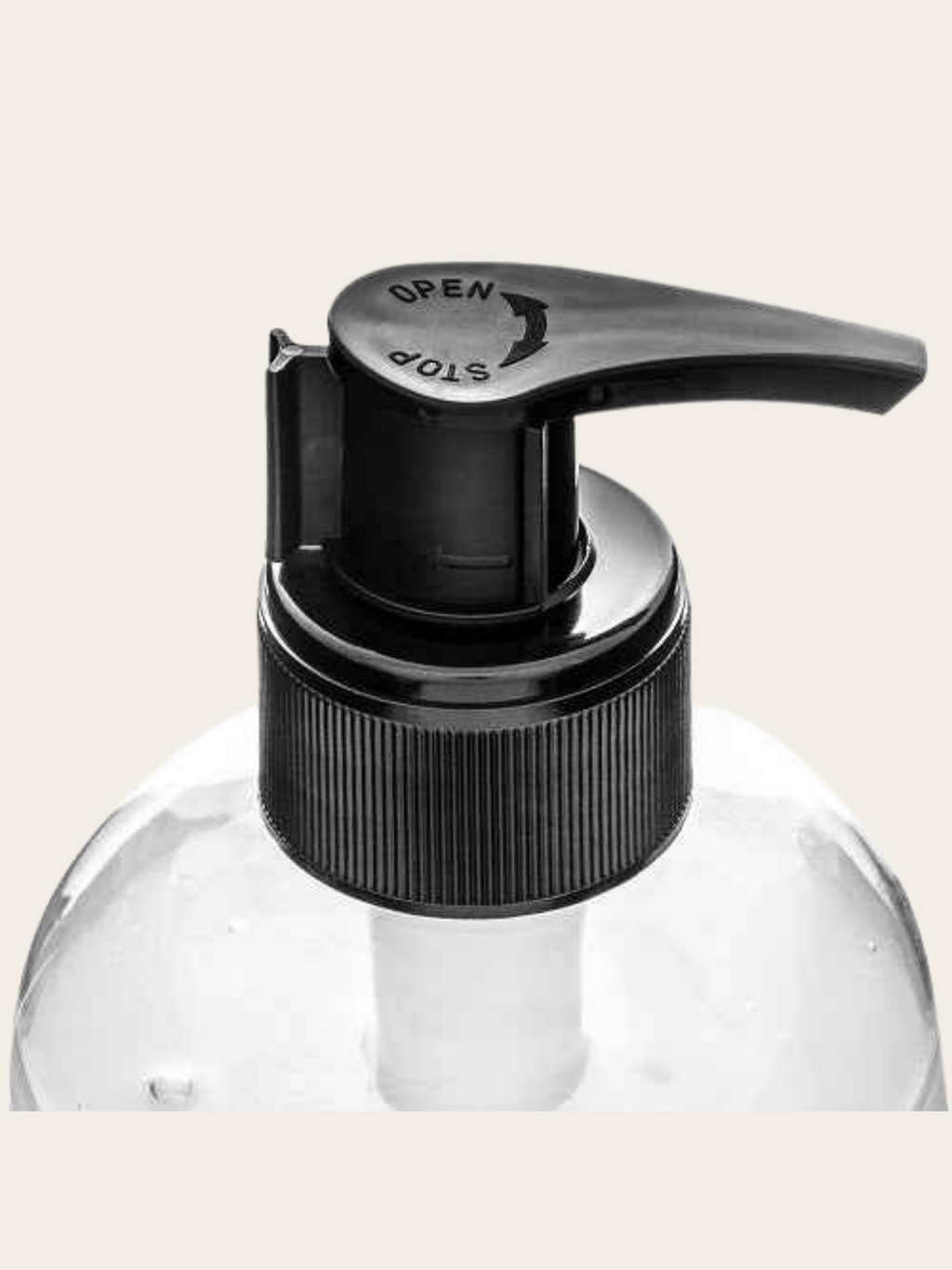 Close-up of a clear plastic pump bottle with a black flip-top dispenser and lever, shown against a light beige background.