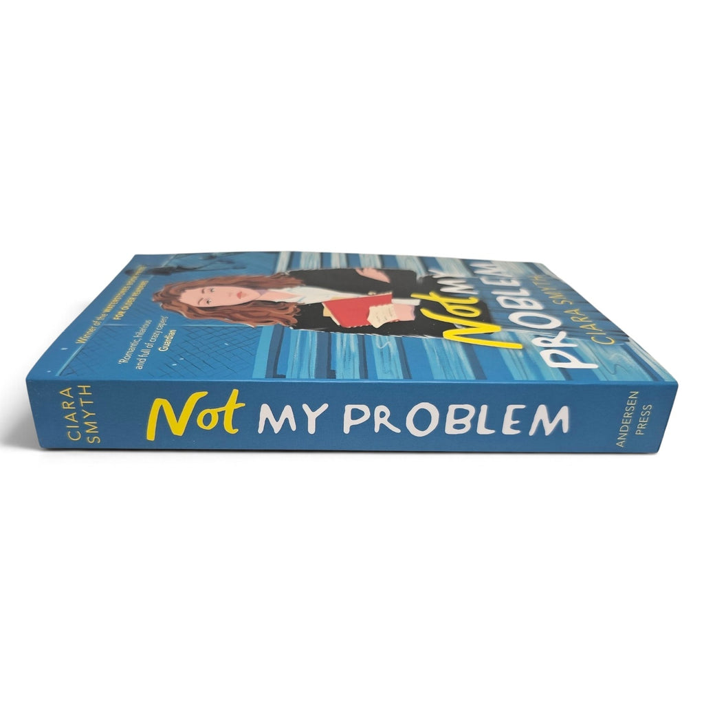 The book 'Not My Problem' by Ciara Smyth is shown from a three-quarters perspective, displaying both the front cover with its illustration and the blue spine.