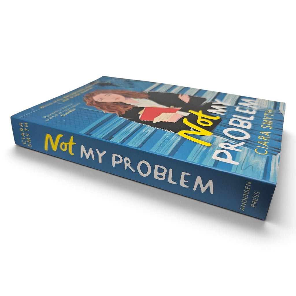 The book 'Not My Problem' by Clara Smith, published by Andersen Press, shown at an angle on a white background. The cover features a blue striped background with an illustration of a woman holding a red cup, and the title is written in bold yellow and white text.
