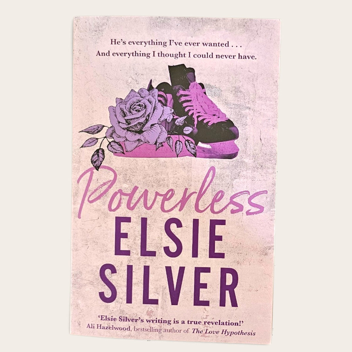 Book cover for 'Powerless' by Elsie Silver, featuring a pink and purple design with an illustration of a shoe and roses, shown against a light beige background.