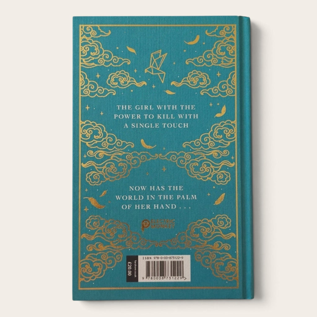 The back cover of a hardcover book featuring a teal background with gold foil cloud patterns, stars, and text, photographed against a light beige background.