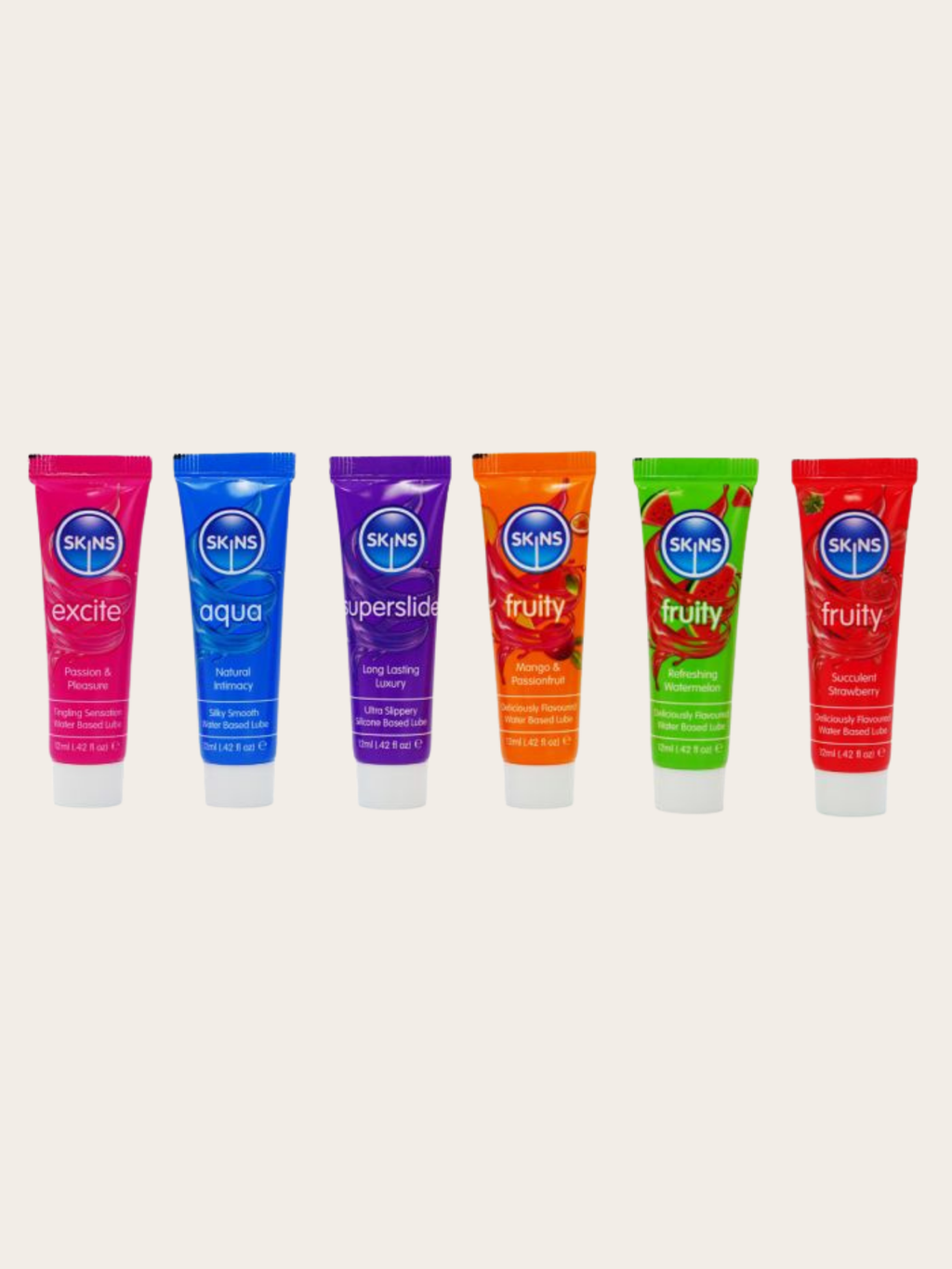 Six tubes of SKINS brand lube in different vibrant colors (pink, blue, purple, orange, green, red) lined up horizontally on a light beige background.