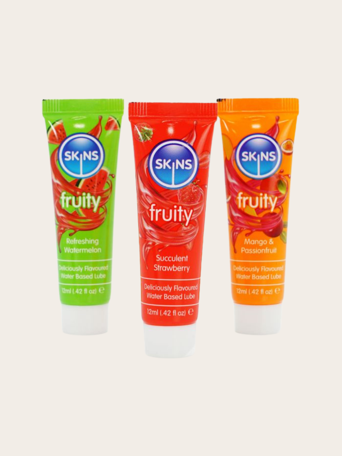 Three SKINS Fruity Water Based Lubricants in squeeze tubes: Refreshing Watermelon (green), Succulent Strawberry (red), and Mango & Passionfruit (orange), arranged on a light beige background.