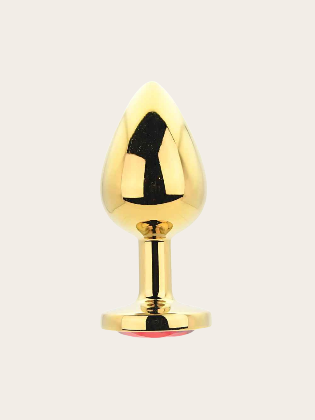A shiny gold metallic butt plug with a teardrop-shaped head and a circular base, shown against a plain light beige background.
