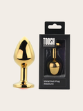 A shiny gold metal butt plug shown next to its black retail packaging box with the brand name TOOSH.