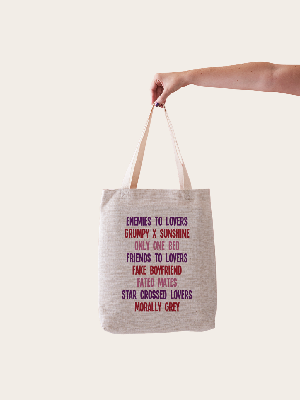 Trope tote bag, featuring a linen tote bag with some popular romance tropes such as "enemies to lovers" "fated mates" and "morally grey"