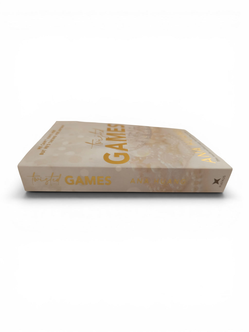 A book titled 'Twisted Games' with a beige cover and gold lettering, shown from a three-quarters perspective on a white background.
