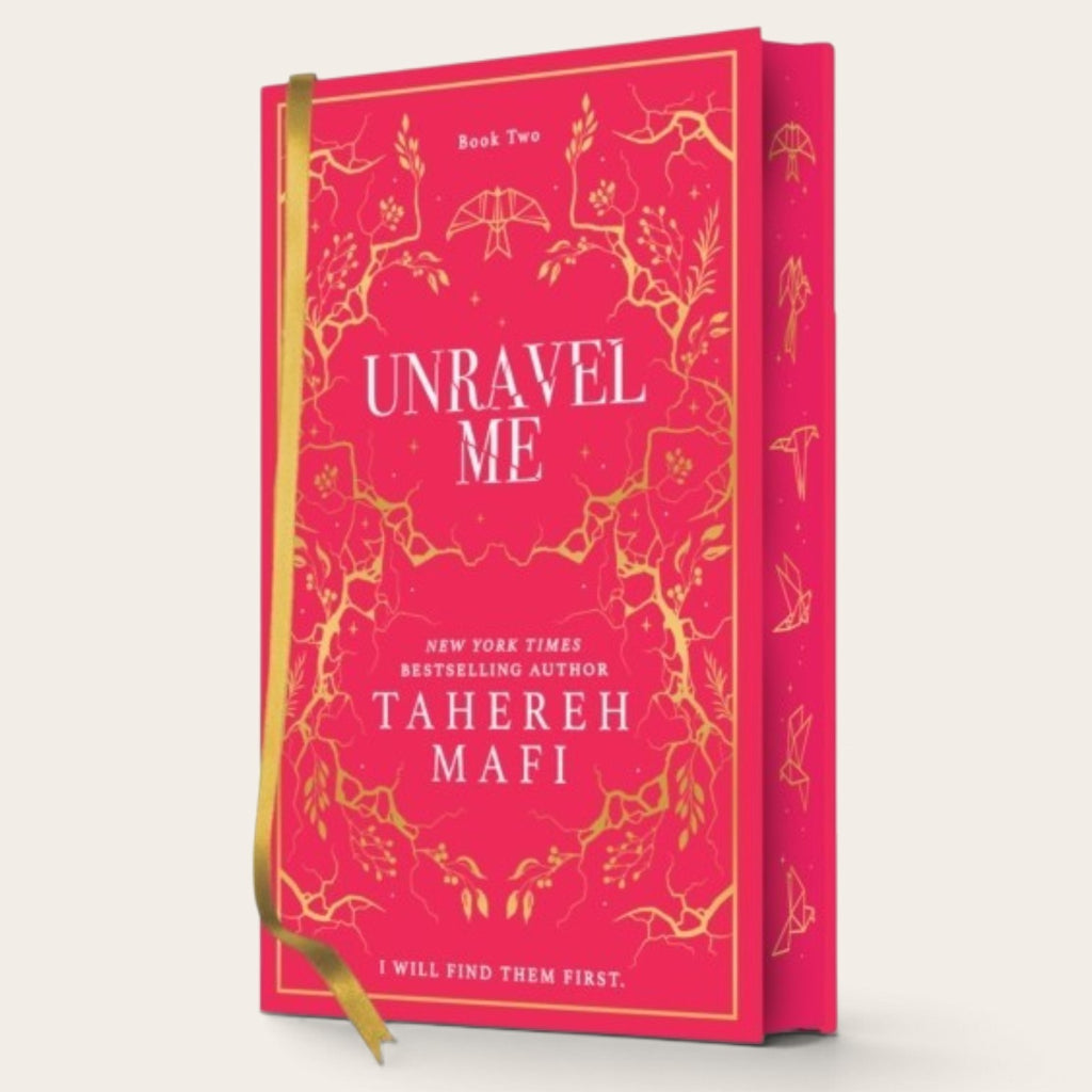 Book cover for 'Unravel Me' by Tahereh Mafi, featuring a bright pink cover with gold floral line art and white text, shown with a gold ribbon bookmark against a light beige background.