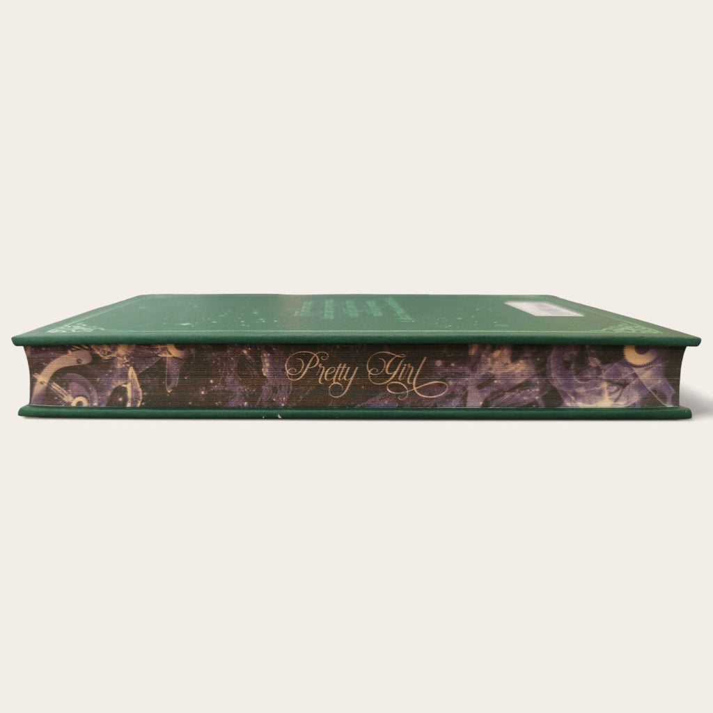 A hardcover book titled 'Wretched' with a dark green cover and a patterned spine featuring purple, gold, and black tones, shown against a plain off-white background.