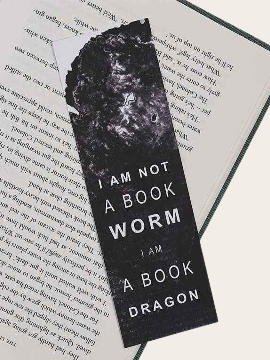 A bookmark with "I am not a book worm, I am  a book dragon" on a book